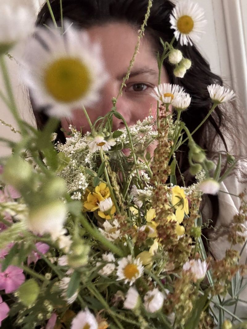 Cherise resting among the wildflowers in her meadow