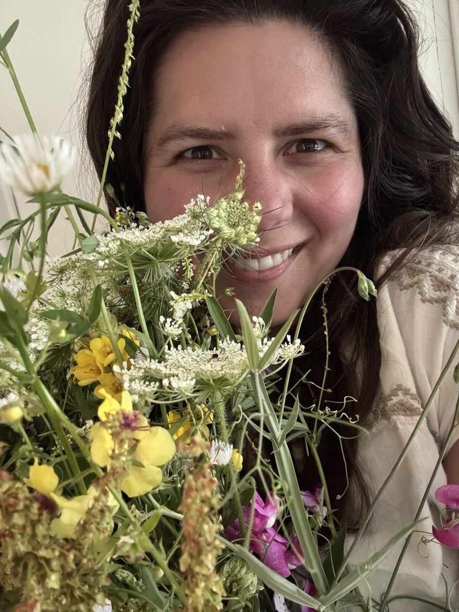 Cherise behind an armful of just-picked wildflowers